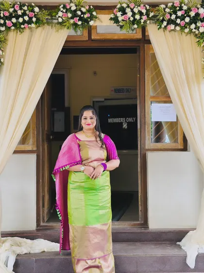 A happy client glowing in a beautiful half saree with a lime green skirt and pink top, perfect for a festive occasion.