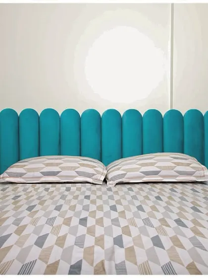 A frontal view of the beautiful teal headboard, demonstrating how a single, bold design choice can define the character of a room.
