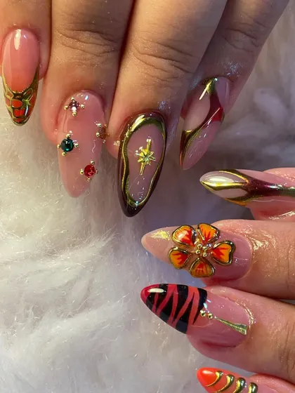 Every nail has its own mood in this eclectic set. We combined animal print, 3D florals, gemstone accents, and chrome details to create a look that is wild, regal, and radiant all at once.