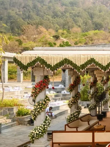 A breathtaking view of a floral-decorated mandap set against a mountain backdrop, showing our ability to create stunning decor in any location.