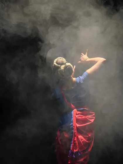 A throwback to a performance in the UK. The smoke and lighting create a mystical atmosphere, transforming the stage and highlighting the dancer's form. Every element of a production contributes to the story.
