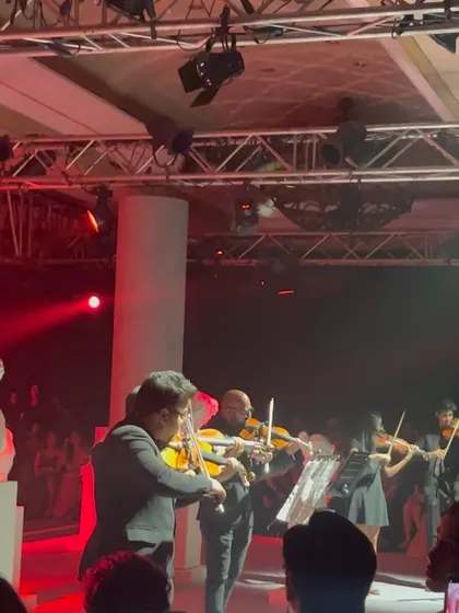 A live orchestra playing at the fashion show, adding another layer of artistry to the event. This reminds me of the various creative elements that need legal consideration.