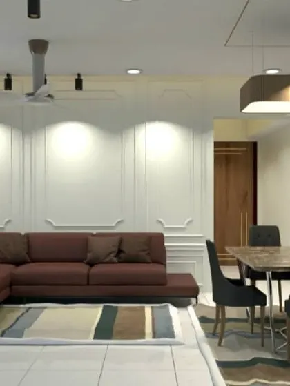 Another shot of the Lodha Amara project, highlighting the spacious feel created by the white walls with moulding and the L-shaped sofa arrangement.