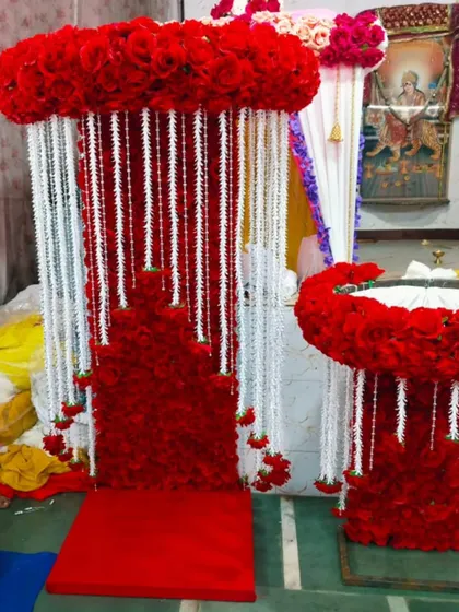 For a truly royal welcome for Bappa, I design elaborate thrones like this one, using dense red florals and contrasting white strings.