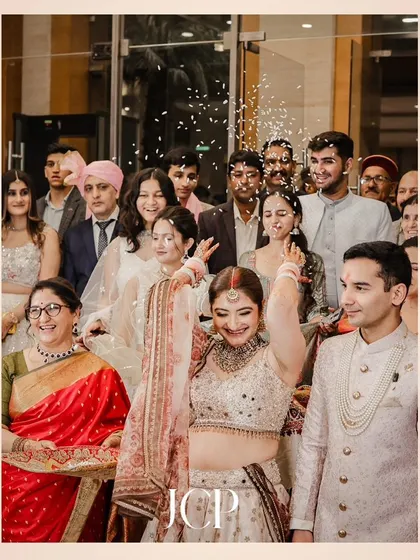 The bride's 'bidaai' or farewell ceremony, throwing rice over her head as she leaves.