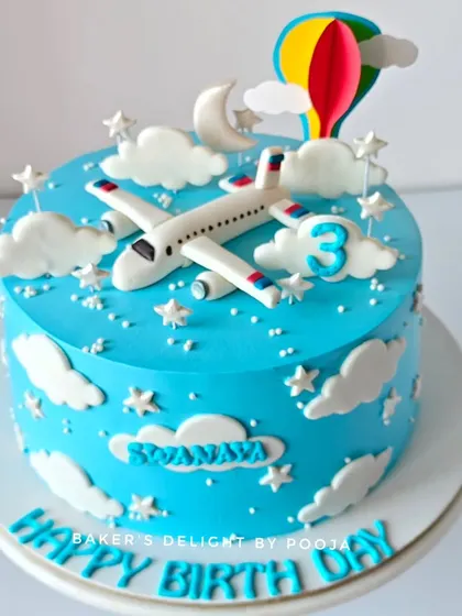 A different view of the airplane cake, showing the handcrafted fondant plane and stars.