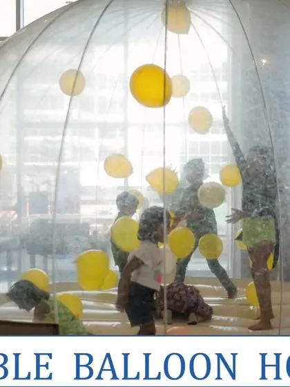 The Bubble Balloon House is a unique and fun activity for kids' parties, where they can play inside a giant transparent dome filled with balloons.