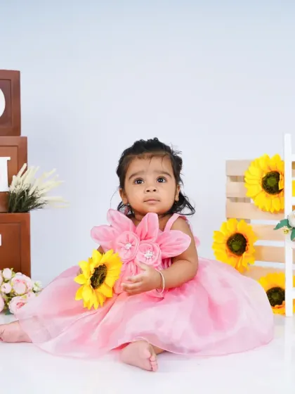 A lovely first birthday shoot with a sunflower and pink dress theme. The combination of bright yellow and soft pink creates a beautiful contrast.