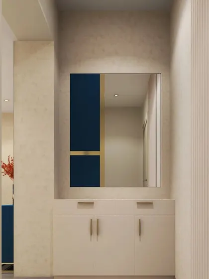 A minimalist foyer with a large mirror that features a bold, color-blocked detail. The simple white console provides discreet storage.
