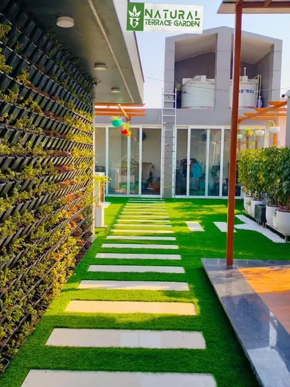 A perspective shot of the pathway and vertical garden in the Sonipat project, demonstrating how we can transform long, narrow spaces.
