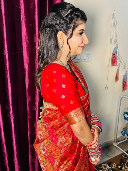 A side view of the half-up, half-down hairstyle with a delicate braid, perfect for a pre-wedding event.