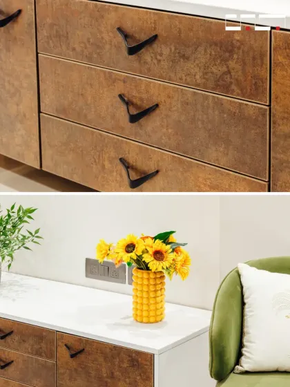 This image showcases the details of the room's custom cabinetry, with unique hardware and a textured wood finish. These small touches of craftsmanship elevate the overall design of the space.