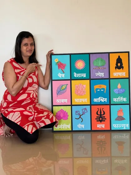 Pointing to the details of the large, custom-sized Marathi calendar. It makes a fantastic statement piece for a living room or hallway.