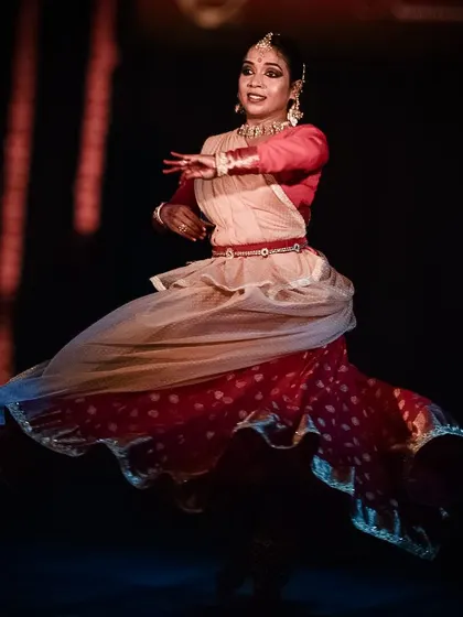 Another angle of the dynamic spin, showcasing the beauty of the Kathak costume in motion.