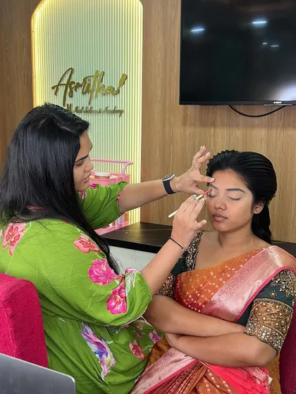 A close-up of a live makeup demonstration, showing the application of eyeliner.
