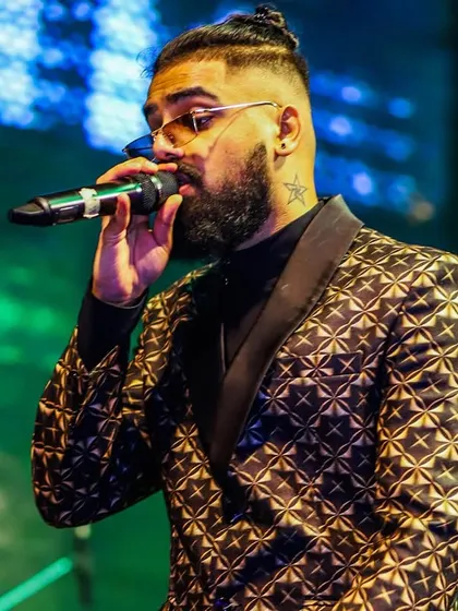 Our vocalist in a stylish patterned blazer, delivering a powerful performance. We pay attention to every detail, from our music to our fashion.