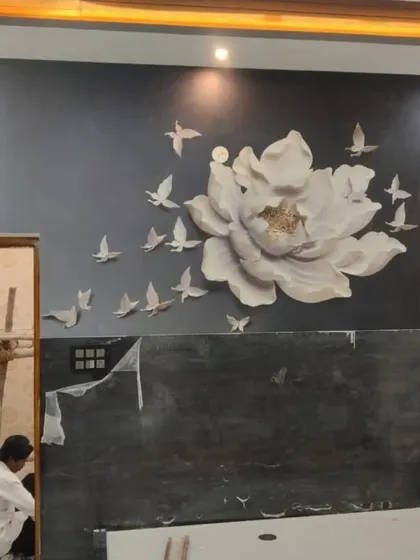 A 3D floral mural with a large white flower and a flock of birds, creating a dynamic and artistic focal point on a dark wall.