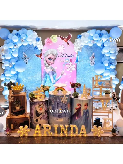 Another angle of the Frozen 5th birthday party, showing the light-up name and detailed pedestals.