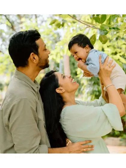 Another beautiful outdoor family portrait. The natural greenery and soft light create a stunning backdrop for their love story.