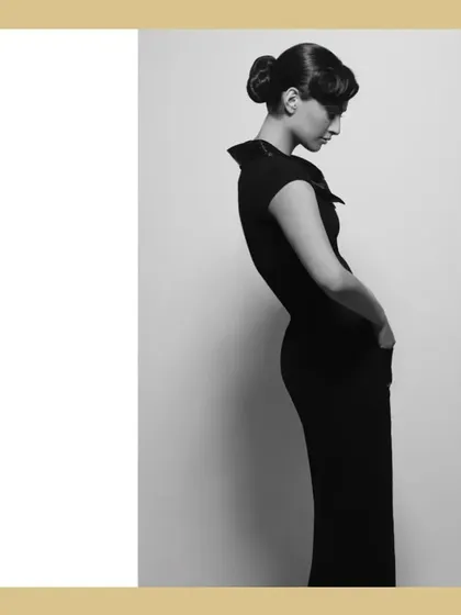 A study in form and silhouette with Sonam Kapoor. This minimalist black and white shot focuses on the elegant lines of her dress and her graceful posture, creating a timeless and artistic fashion portrait.