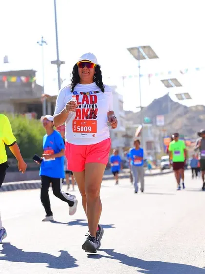 A participant running strong through the streets of Leh during the marathon. The local community and fellow runners create an amazing atmosphere of support.