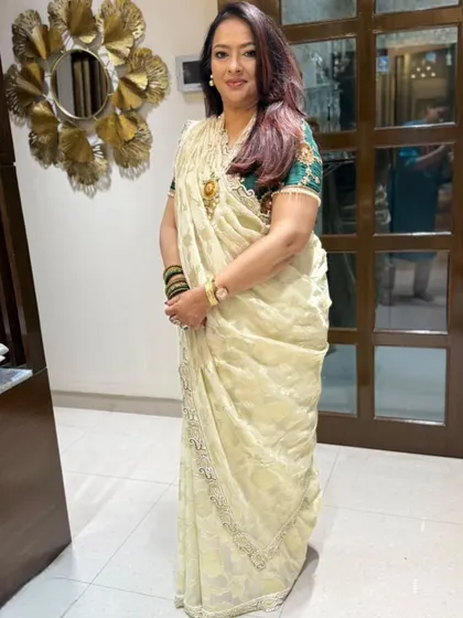 Another shot of the radiant Dr. Geetanjali in her elegantly draped off-white saree.