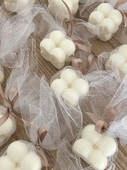 Mini bubble candles packed in delicate net potlis with satin ribbons. This is an elegant and affordable packaging option.
