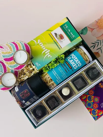 A tilted view of the floral box, showing the "Soothe" green tea and other relaxing goodies inside.