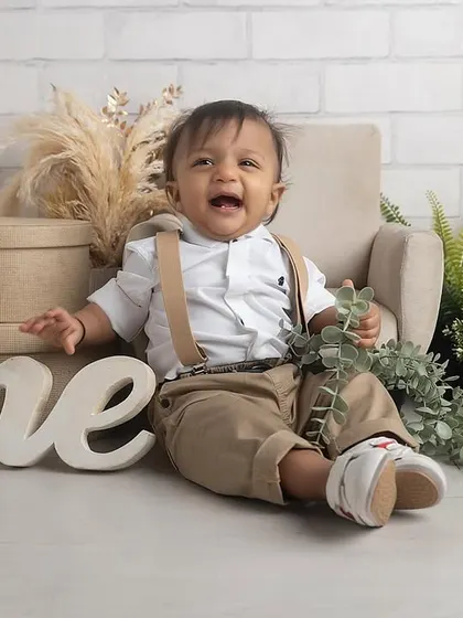 A big, happy laugh from the birthday boy! This little man is celebrating his first birthday with a stylish, rustic-themed cake smash session in the studio.