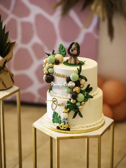 Another gorgeous cake from a 'Wild One' party. This two-tiered cake features cute fondant animals and a clean, modern design that stands out on the dessert table.