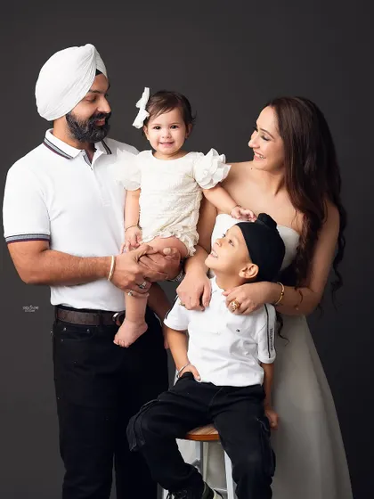 So much love and happiness in one frame. This family portrait is full of interaction and smiles, showing the beautiful bond between parents and their two children.