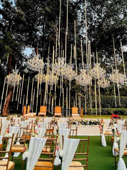 We designed this spectacular open air mandap to feel like a modern fairytale. The combination of suspended golden rods and crystal chandeliers under a canopy of ancient trees created a truly magical setting for the wedding ceremony at Amaara Farms.