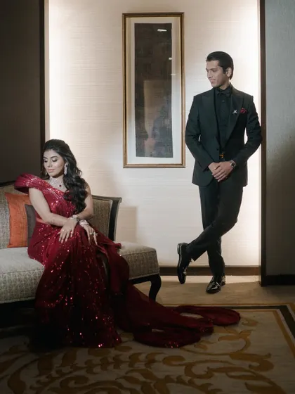 An elegant, full-length portrait of the couple in their reception attire. We focus on creating sophisticated and classic images that showcase your style.
