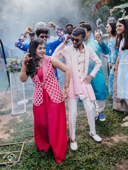 The couple and their friends dancing with abandon during a fun outdoor pre-wedding event.