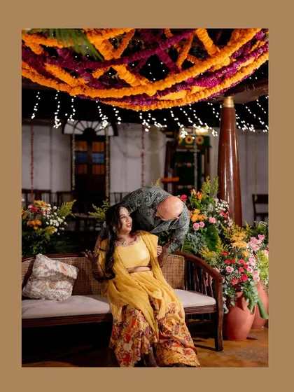 An intimate portrait of the couple sharing a quiet moment during their Mehendi night, surrounded by the vibrant colors and festive energy of the celebration.