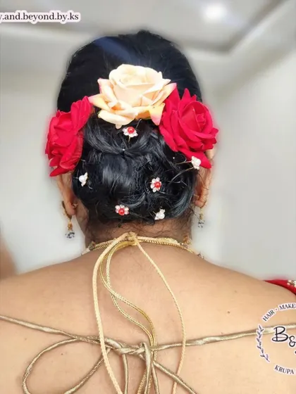 Here is another beautiful example of a messy updo with fresh roses and small rhinestone accessories. This look was created for the aunt of the bride, showing how a textured bun can be both glamorous and age-appropriate.