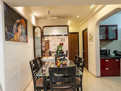 This view shows the dining area in relation to the kitchen entrance. The layout is practical, making it easy to serve meals while maintaining a distinct zone for dining.