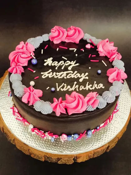 This is my Dutch Truffle cake, decorated with beautiful pink and grey floral piping. It's a classic, rich chocolate cake that's perfect for birthdays and celebrations.
