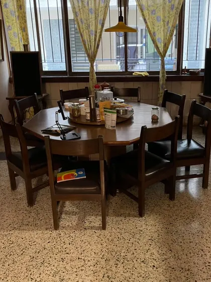 **BEFORE:** The client's original octagonal dining table, a cherished family heirloom, but with a dated finish and seated at a lower, less ergonomic height.