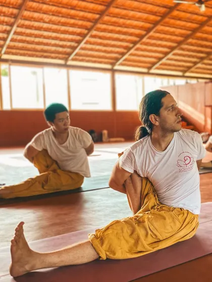 Students practice Ardha Matsyendrasana (Half Lord of the Fishes Pose), a powerful spinal twist. This posture detoxifies the organs and improves spinal mobility. We focus on twisting from the core while keeping the breath steady.
