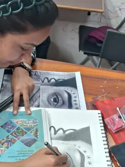 An adult student in our General Art Foundation course uses a reference to practice a detailed eye drawing. We welcome learners of all ages who want to build or improve their art skills.