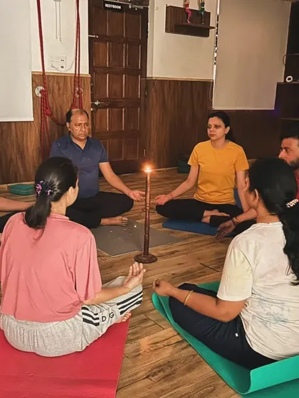 I often explain the technique and benefits of practices like Tratak meditation before we begin. Here, a group listens as we prepare to start our candle-gazing session.