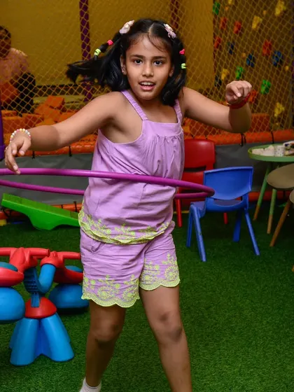 Hula hooping like a pro! It's a great activity for kids to show off their skills.