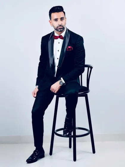 The classic black tuxedo is a symbol of elegance. This full-length shot shows the impeccable fit and sharp silhouette that can only be achieved with a custom-made garment.