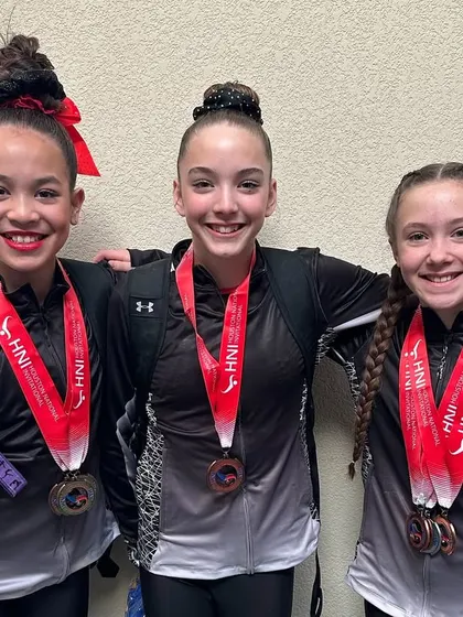Three of our Optional Team athletes loaded with medals after a successful HNI meet.