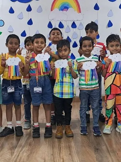 A group of boys shows off their colorful rainbow crafts, made during our fun-filled classroom activity.