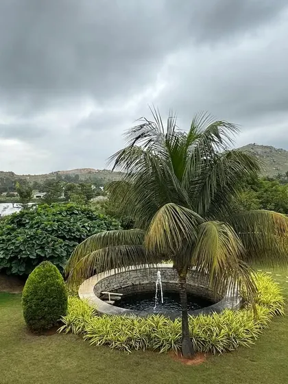 A view of our well-maintained gardens and fountain, with the lake and hills beyond. The sound of the water and the sight of the greenery are integral parts of the sensory healing experience here.