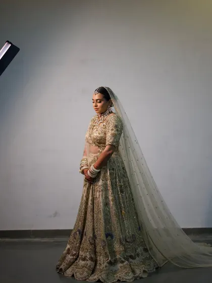 A dramatic, full-length shot of the bride, with her long veil creating a stunning silhouette.