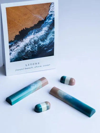 'Litore', meaning coast. These chocolate bars beautifully replicate the gradient of a beach meeting the ocean, a perfect example of how we draw inspiration from nature to create edible art.