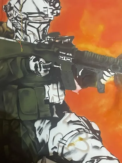 A mid-process shot of the laser tag mural, showing the layers of color being built up.